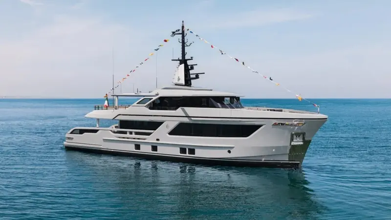 Closer on the three-quarter, showing the glazing band along the main deck and the raised pilothouse set well forward.