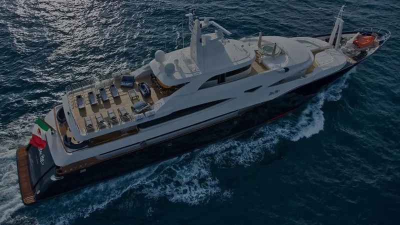 An aerial view forward over the bow, showing the raised foredeck seating area and the yacht's flared bow entry.