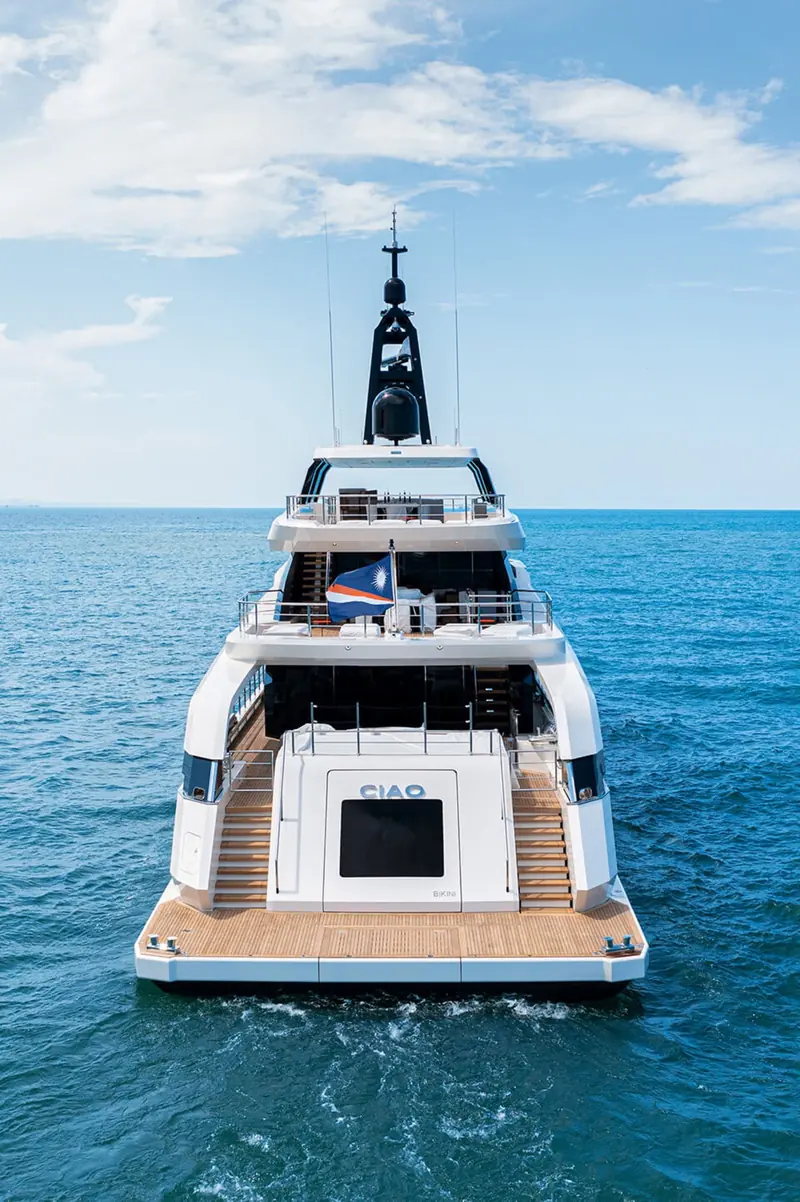 A bow-on view of Ciao underway, the low freeboard and wraparound glazing visible head-on.