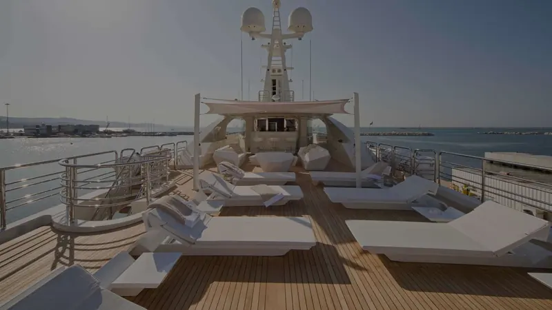 The foredeck seen from the bow, sunpads and a raised helicopter-landing style platform occupying the space forward of the bridge.