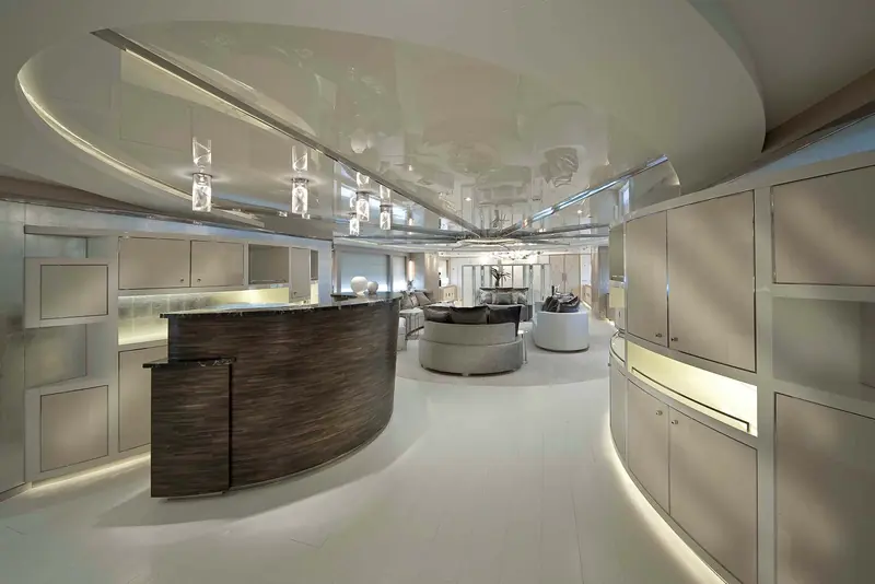 An interior lounge with a mirrored, saucer-shaped ceiling feature over a curved bar counter, lit for evening use.