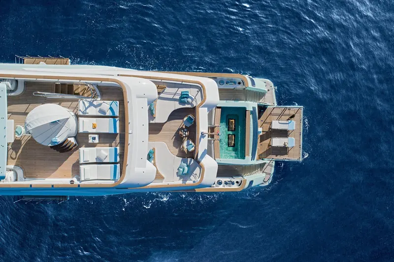 An overhead view of the stern swim platform and integrated pool arrangement, shot from directly above.