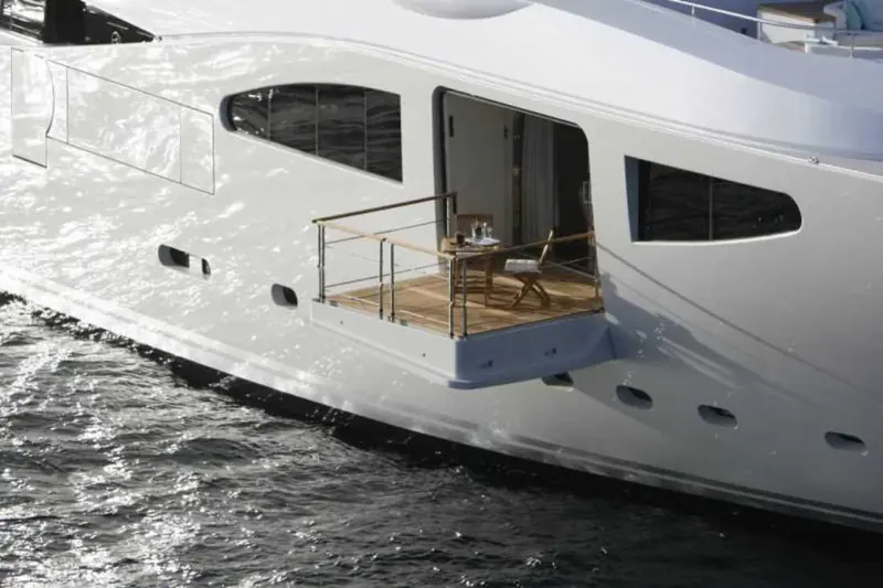 A close view of Maraya's bow with a balcony door folded open onto the sea, showing how the forward accommodation opens directly to the water.