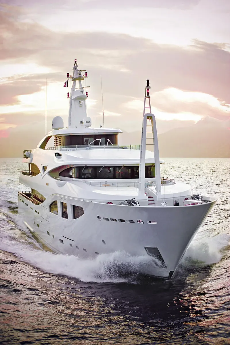 Maraya photographed bow-on at dusk, her hull lit warm against a darkening sky.