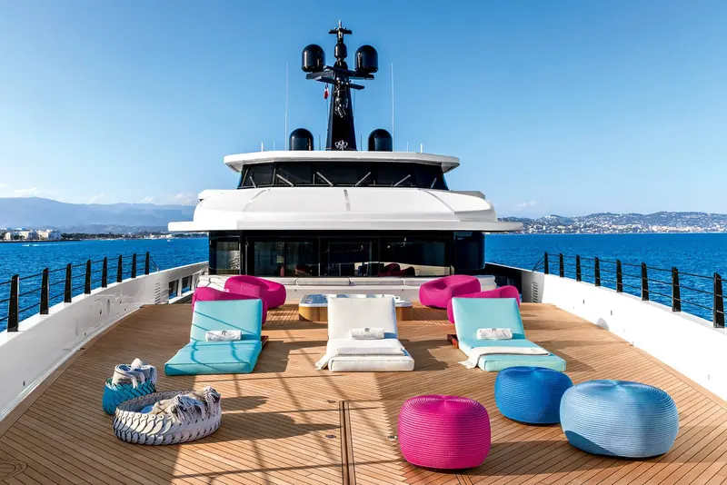 The upper sundeck laid out with pink and teal beanbags rather than fixed loungers, a deliberately casual furniture choice for the space above the wheelhouse.