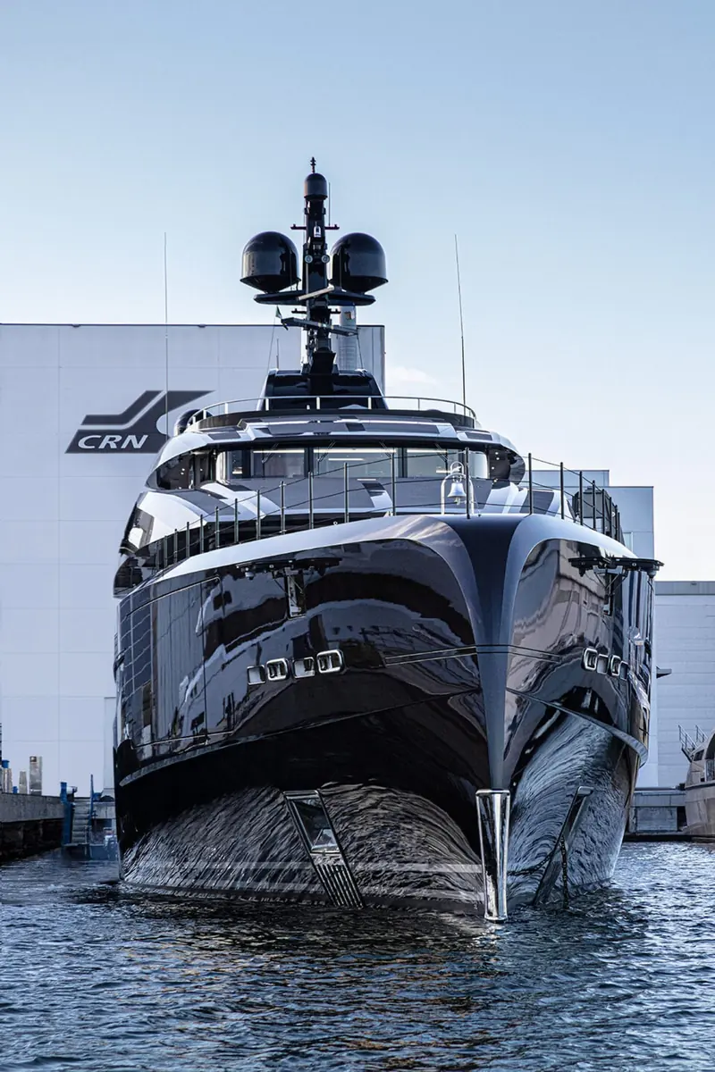 Voice's bow at the CRN yard in Ancona immediately after launch, the shipyard's own building and CRN signage visible behind the hull.