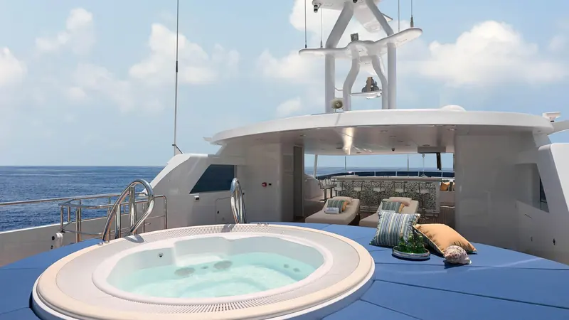 The sundeck spa pool seen from above, sized for four and set into a raised deck section aft of the funnel.