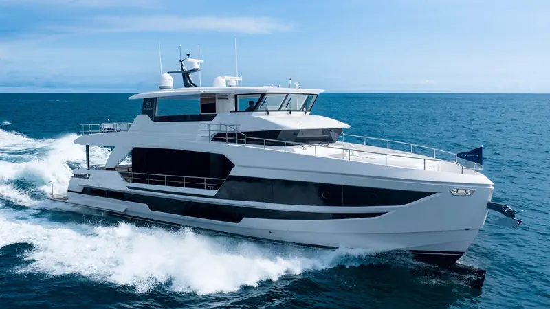 Bow-on underway, twin radar arch masts and the wraparound glazing that carries around the pilothouse front.