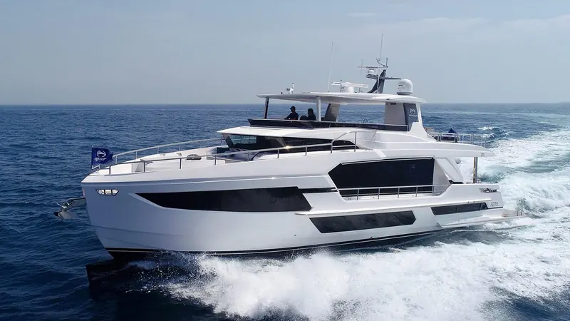 Broadside at speed in flatter water, showing how little of the hull sits below the waterline compared with a full-displacement trawler.