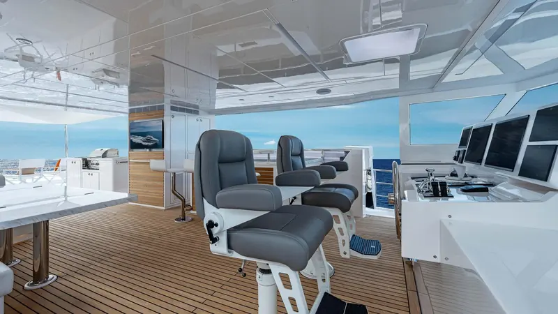 The lower helm, twin captain's chairs facing a console built for a single main chartplotter and analogue backups.