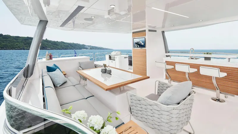 Looking aft from the saloon through to the cockpit, glass doors folded away to join the two spaces.