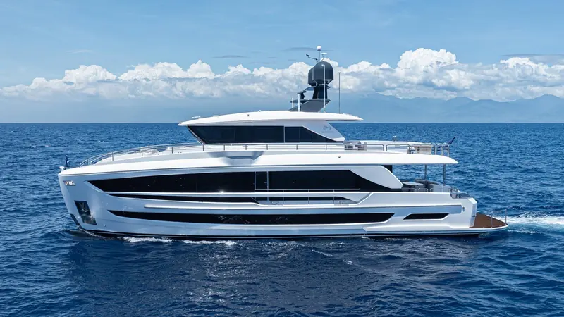 An FD80 lies beam-on in open water, the glazed bands of both decks running almost the full length of the hull.