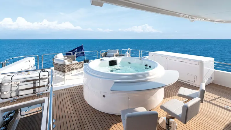 The spa pool on the upper deck, set forward of the seating and clear of the tender crane.
