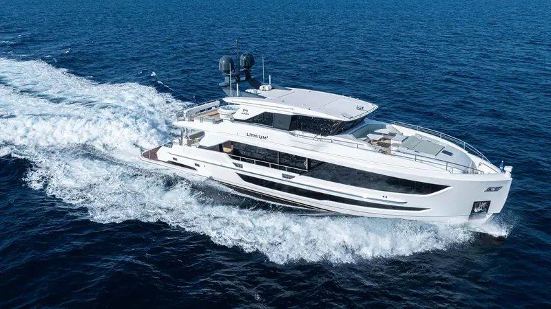 Running at speed, showing the FD90's twin-engine wake and the black window band that runs the length of the hull.