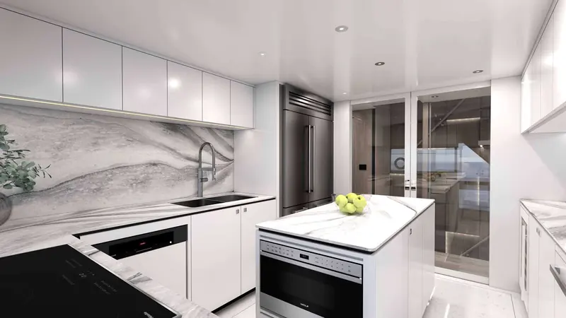 The galley pairs a Sub-Zero column refrigerator with a Wolf built-in oven and induction cooktop, finished in book-matched grey marble.