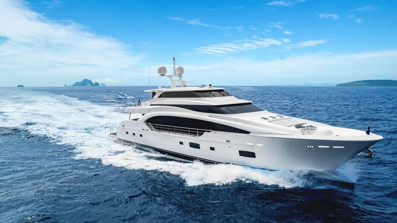 RP110 on a running shot off the Thai islands near Phuket, her raked bow throwing a clean double wake at speed.