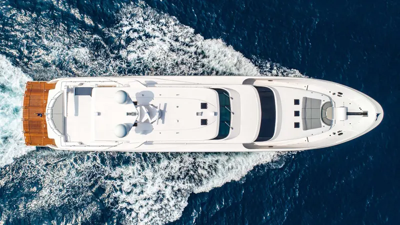 Overhead, the foredeck sunpads and helm-deck glazing show how much of the RP110's 33.5m runs as usable outdoor space.