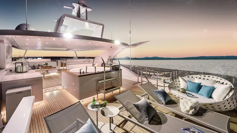 The flybridge galley and lounge at dusk, open on three sides with a hardtop overhead.
