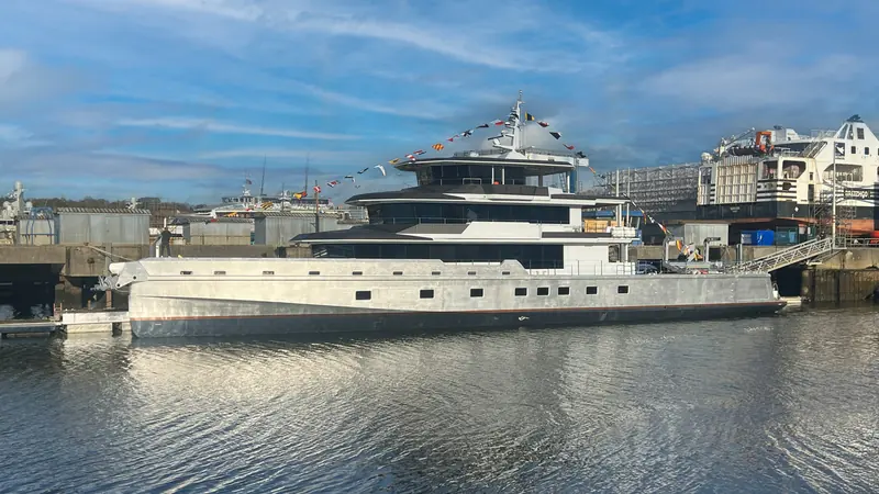 Canoa dressed with signal flags on launch day at JFA's Concarneau yard, January 2026, her hull still unpainted.
