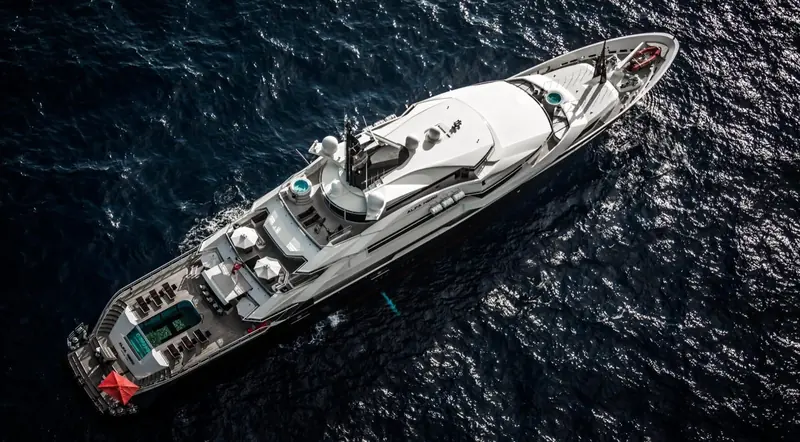 An aerial view straight down onto the foredeck and bridge, wake fanning out astern.
