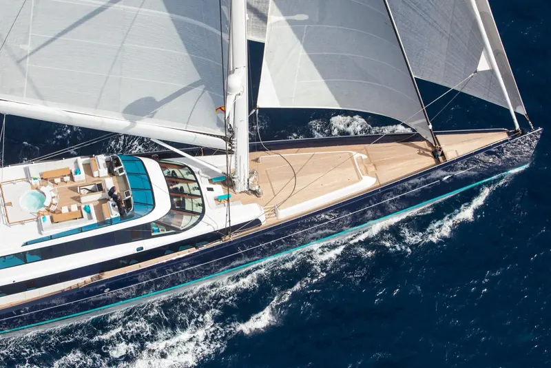 Running under sail, an aerial view showing the full deck layout from bow to cockpit.