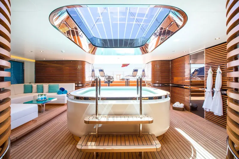 The below-deck spa, its glass skylight framing the masts and rigging reflected above the plunge pool.