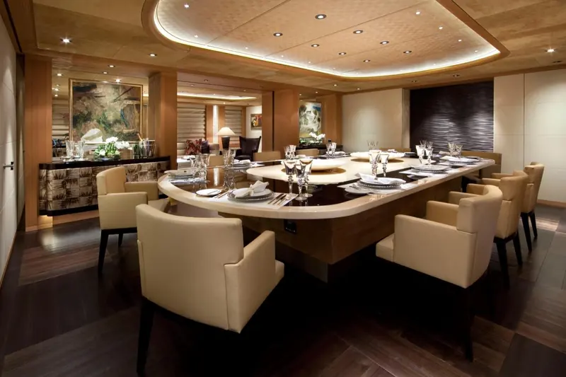 The formal dining room, laid for a full table beneath a coffered ceiling.