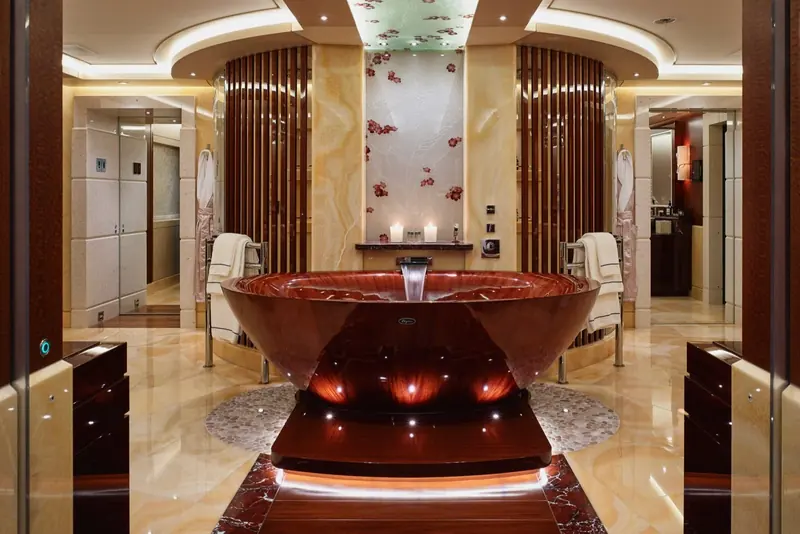The master bathroom's onyx bathtub, carved as a single free-standing basin lit from beneath.