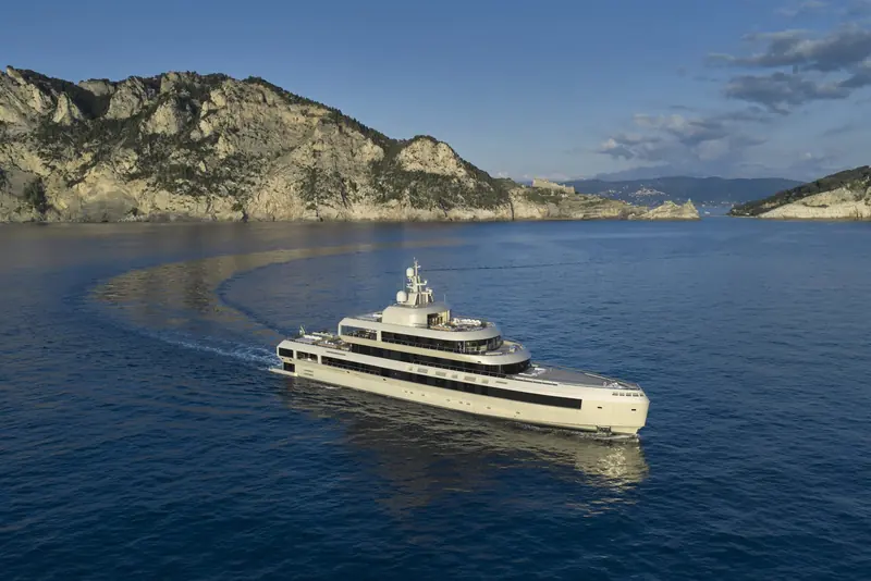 Admiral 72 by Giorgio Armani carves a turn off the Ligurian coast near her Marina di Carrara launch point, the wake curling back on itself in the low evening light.