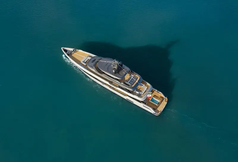 Overhead, the semi-custom Panorama layout is visible end to end: foredeck seating forward, a shaded midships lounge, and a plunge pool set into the teak aft deck.