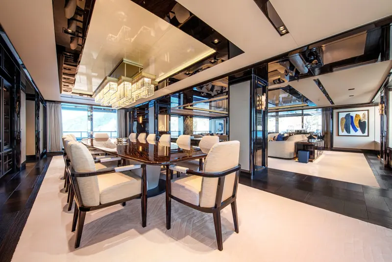 The formal dining room seats eight at a dark wood table, opening directly into the adjoining lounge rather than being closed off as a separate room.