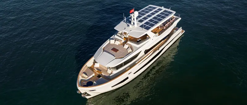 An aerial view showing the full solar canopy over the flybridge, the working foredeck and the tender garage aft.