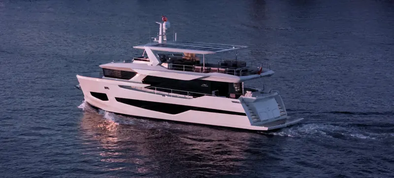 Running at speed in evening light, showing the reverse bow and the low-profile superstructure the 27XP shares with the rest of the XP line.