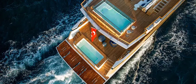 Looking straight down at speed, the 40XP carries two full-size plunge pools stacked one above the other, main deck and beach club, rather than the usual single pool aft.