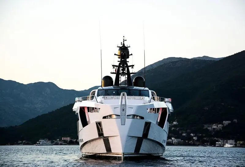 Head-on into Kotor's fjord-like bay, the sculpted forward superstructure framed by Montenegro's mountains.