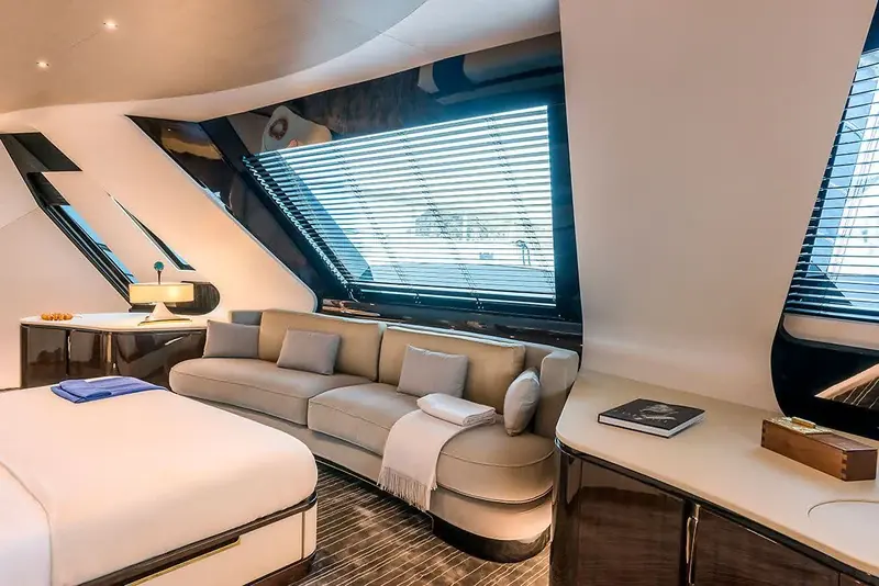 A private sitting area with venetian blinds lowered against the sun, high-gloss wood panelling reflecting the room.