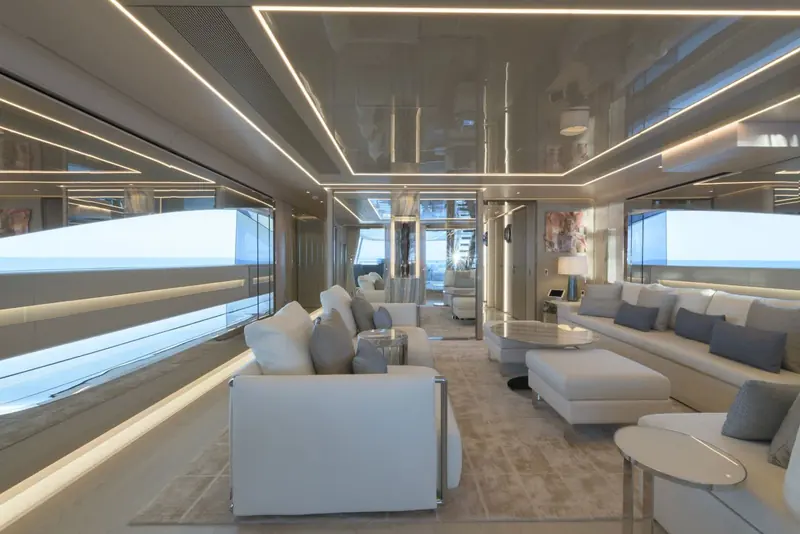 The main saloon's low, deep seating faces full-height glazing that turns the horizon itself into the artwork.