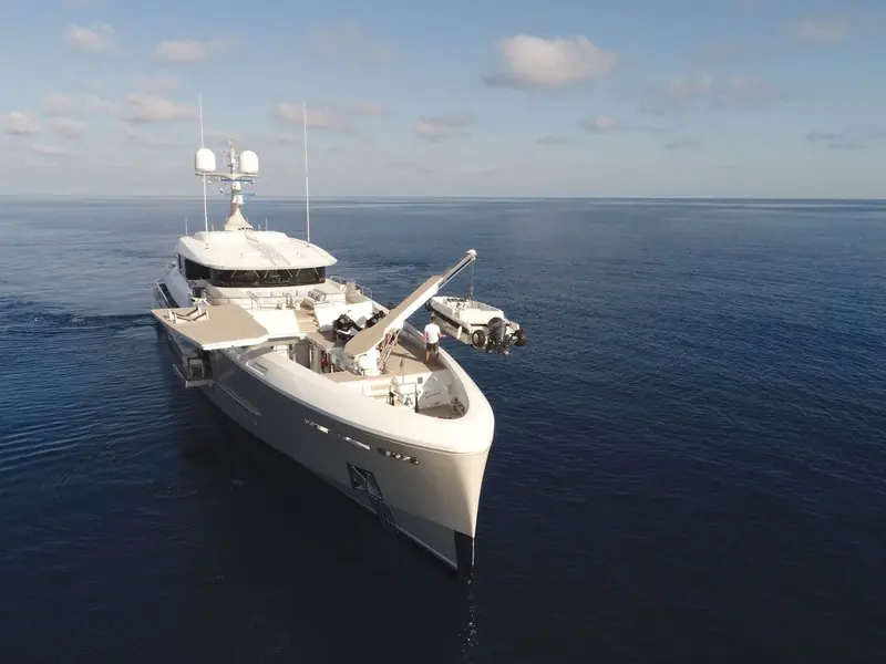 An aerial bow view showing the raked, near-vertical stem and the exposed foredeck worktop, both explorer-yacht cues rather than the flared bows common on planing hulls.