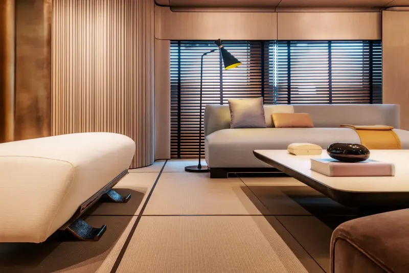 A guest lounge floored in tatami matting with sliding timber screens, a deliberately Japanese register that runs through several of the interior spaces rather than the usual Italian yacht palette.