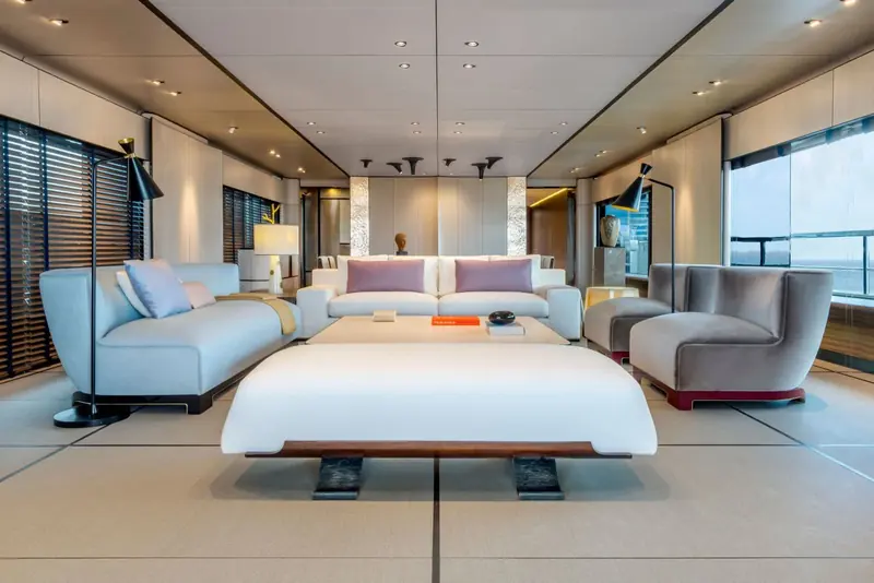 A guest cabin continuing the tatami-and-screen theme, with low, upholstered furniture set closer to the floor than the Western-height seating used elsewhere on board.