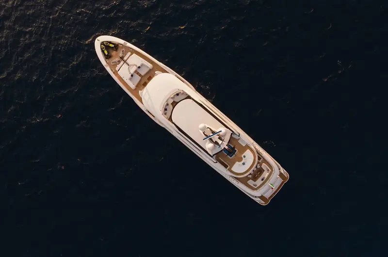 A straight-down aerial pass, useful for seeing how little of the deck is given over to walkways versus usable lounging and dining space fore and aft.