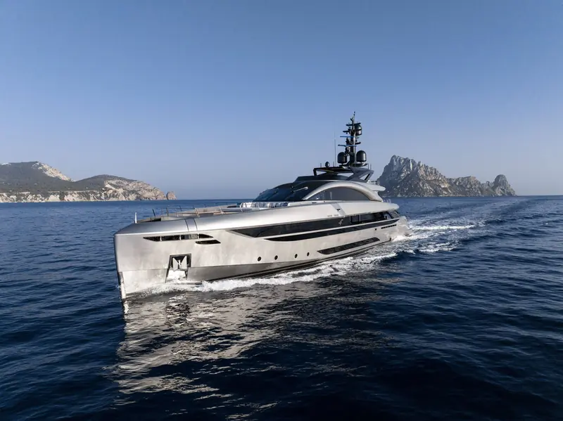 Running past Es Vedra at speed, the flush aluminium hull throwing a clean, symmetrical wake either side.