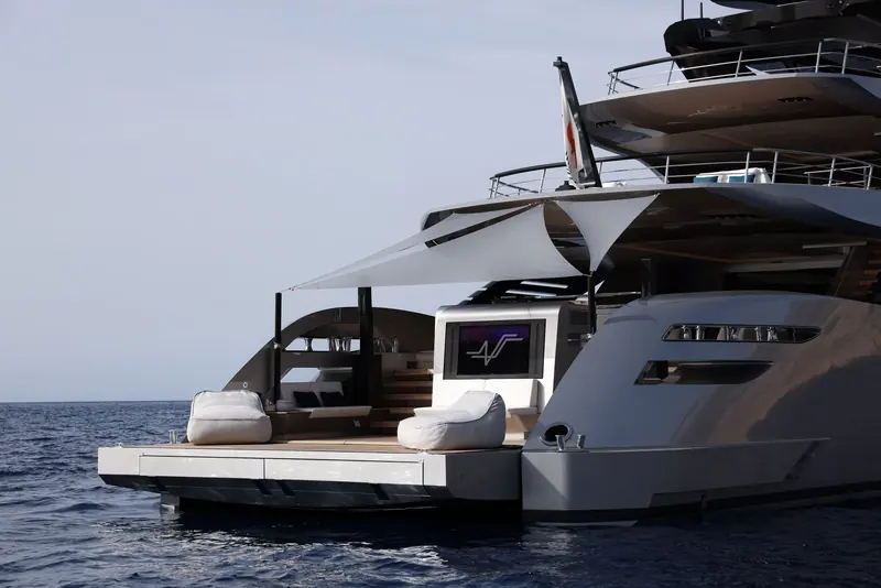 The fold-down transom platform doubles as a beach club, with a drop-down screen and bean bags replacing the tender that would normally stow here.