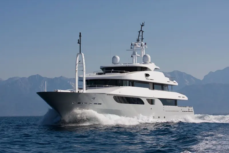 Running past Cannes with the Alpes-Maritimes behind it, the raked mast and radar arch sit low enough to keep the profile from reading as top-heavy.