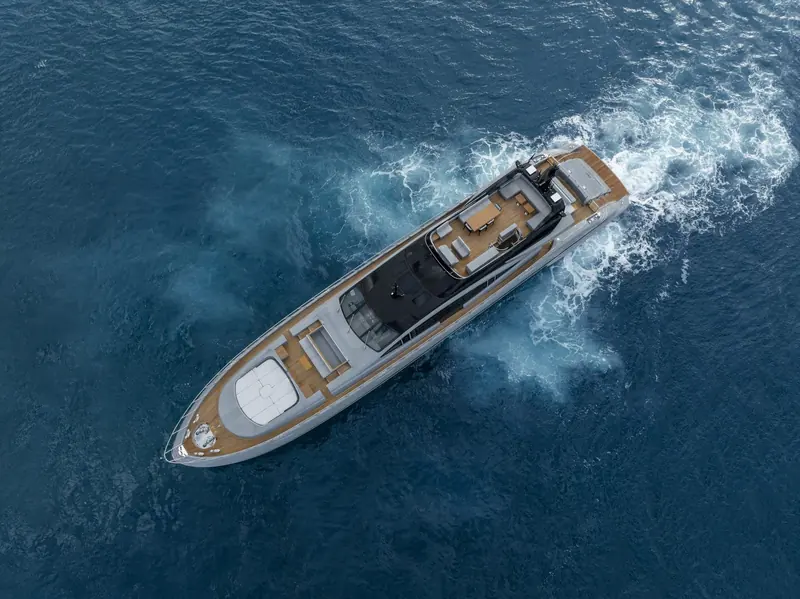 A straight-down aerial at speed shows the full deck plan: the low, glazed superstructure and open cockpit that keep the 132E's silhouette closer to a sportsboat than a displacement yacht.