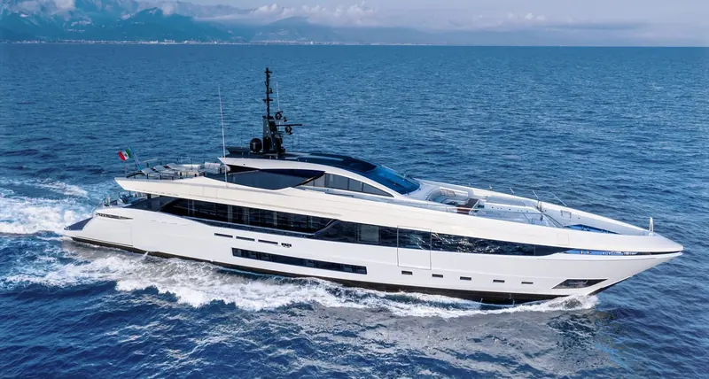 The Mangusta GranSport 45 underway, her low sheer line and reverse bow cutting a clean wake in open water.