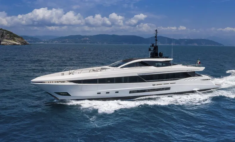 The GranSport 45 running along a rocky coastline, seen from a following boat.