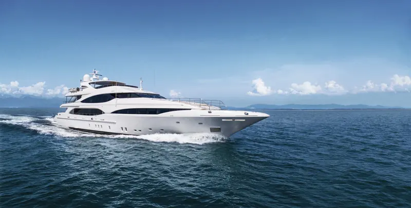 Profile view under way, showing the Oceano range's low, glass-heavy superstructure and the walkaround side decks that replaced Mangusta's older enclosed-saloon layout.