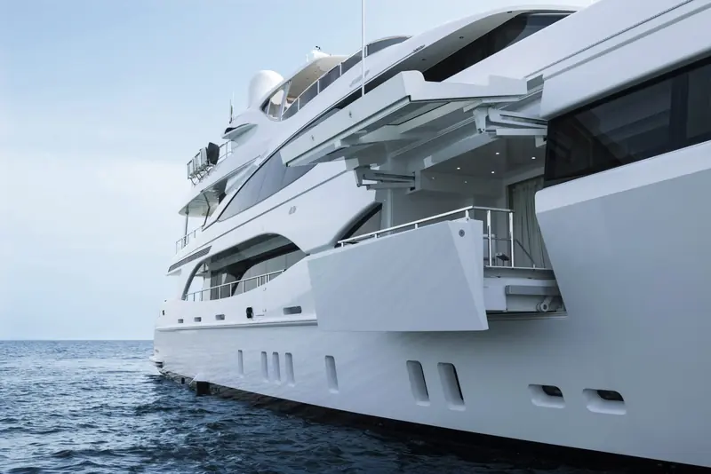 The port-side fold-down balcony deployed at anchor, opening a stateroom onto its own private terrace - one of the model's signature features.
