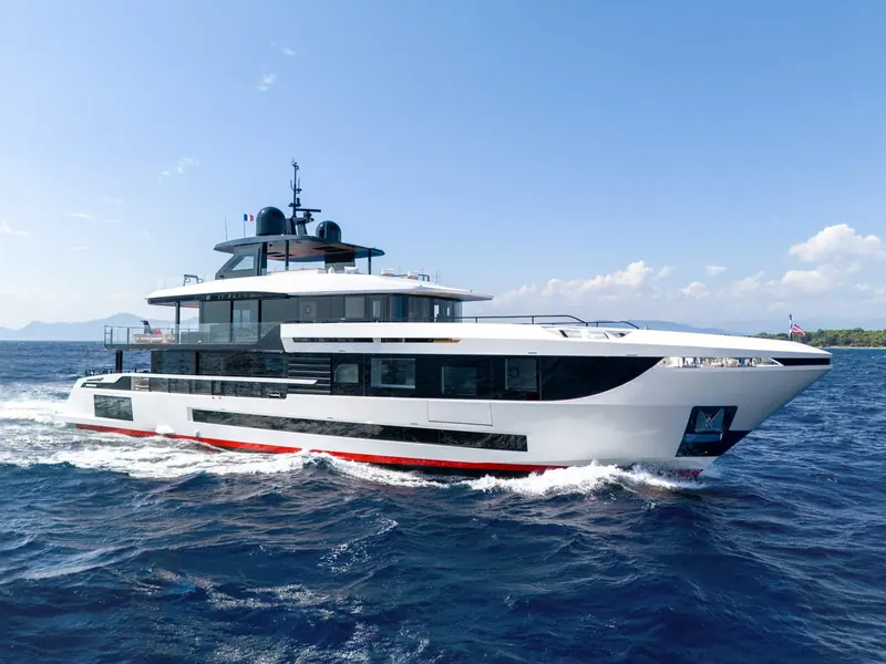 Underway under a French flag, the raised pilothouse and full-beam upper deck saloon that mark the Oceano range out from Mangusta's sportier open models.